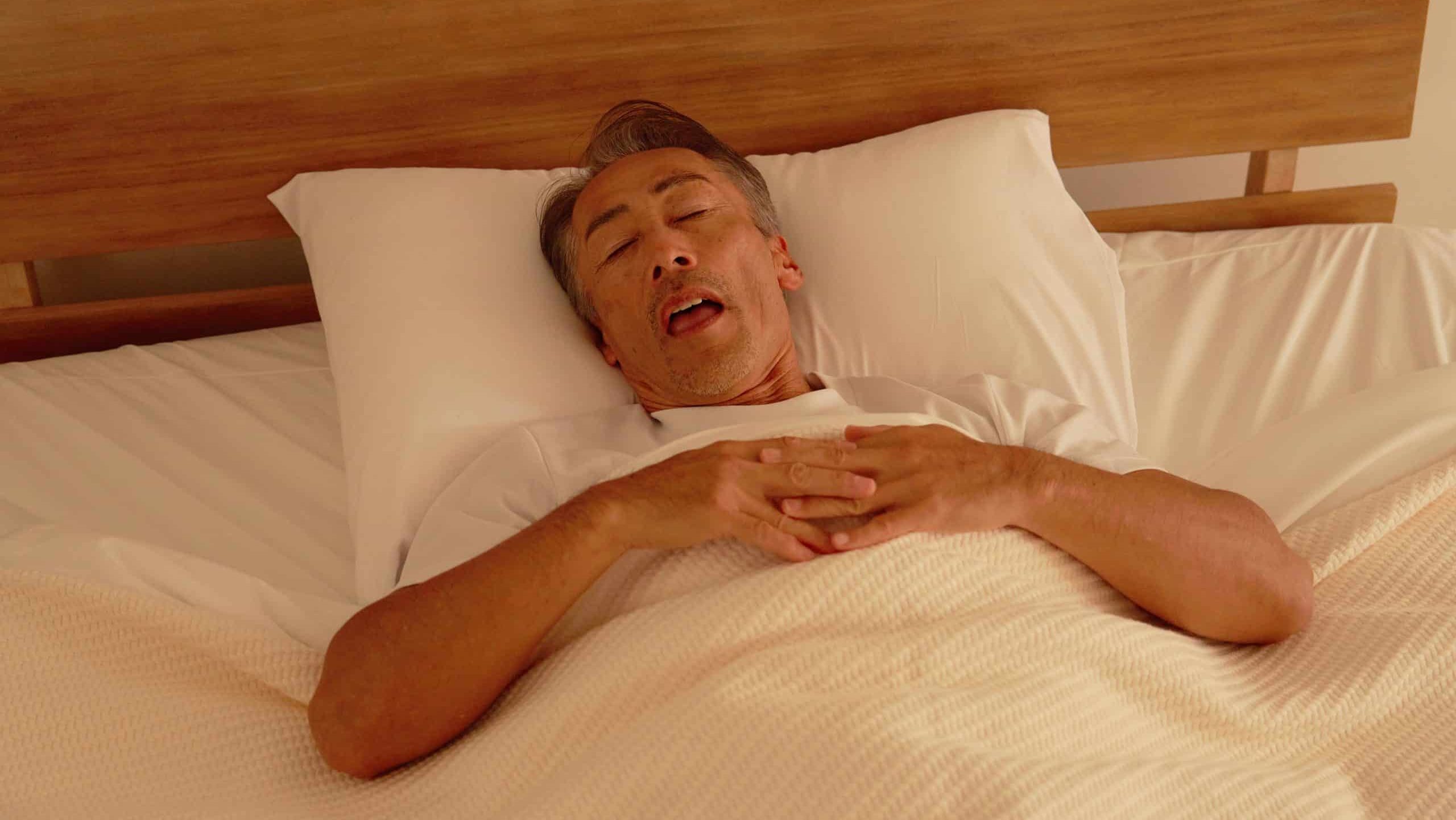 Asian elderly man sleeping in the bedroom