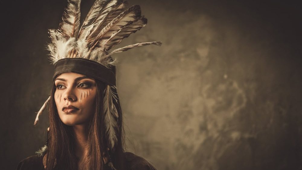 Woman with traditional indian headdress and face paint