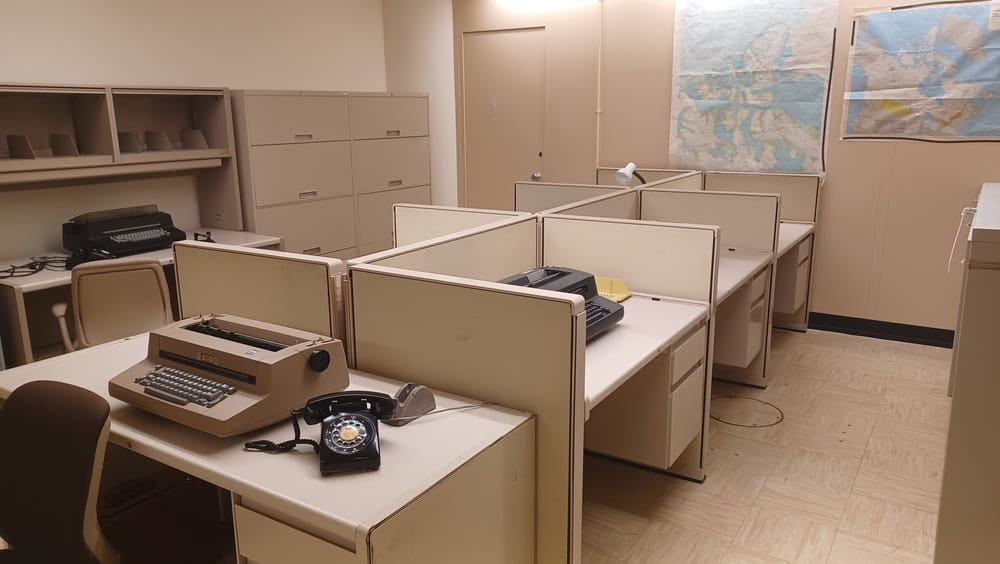 Ottawa, ON, Canada - August 9, 2025: Cold War era office interior with vintage typewriters, rotary phone, and cubicles, preserving historical communication methods