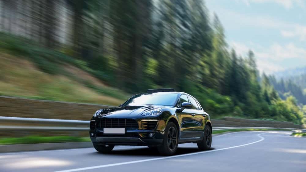 Black,Car,Driving,On,Asphalt,Road,,Motion,Blur,Effect