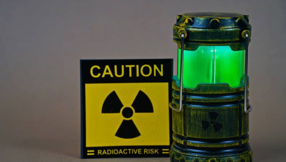 A nuclear reactor. Lamp-figurine and symbol of radioactivity with the inscription: caution, radioactive risk