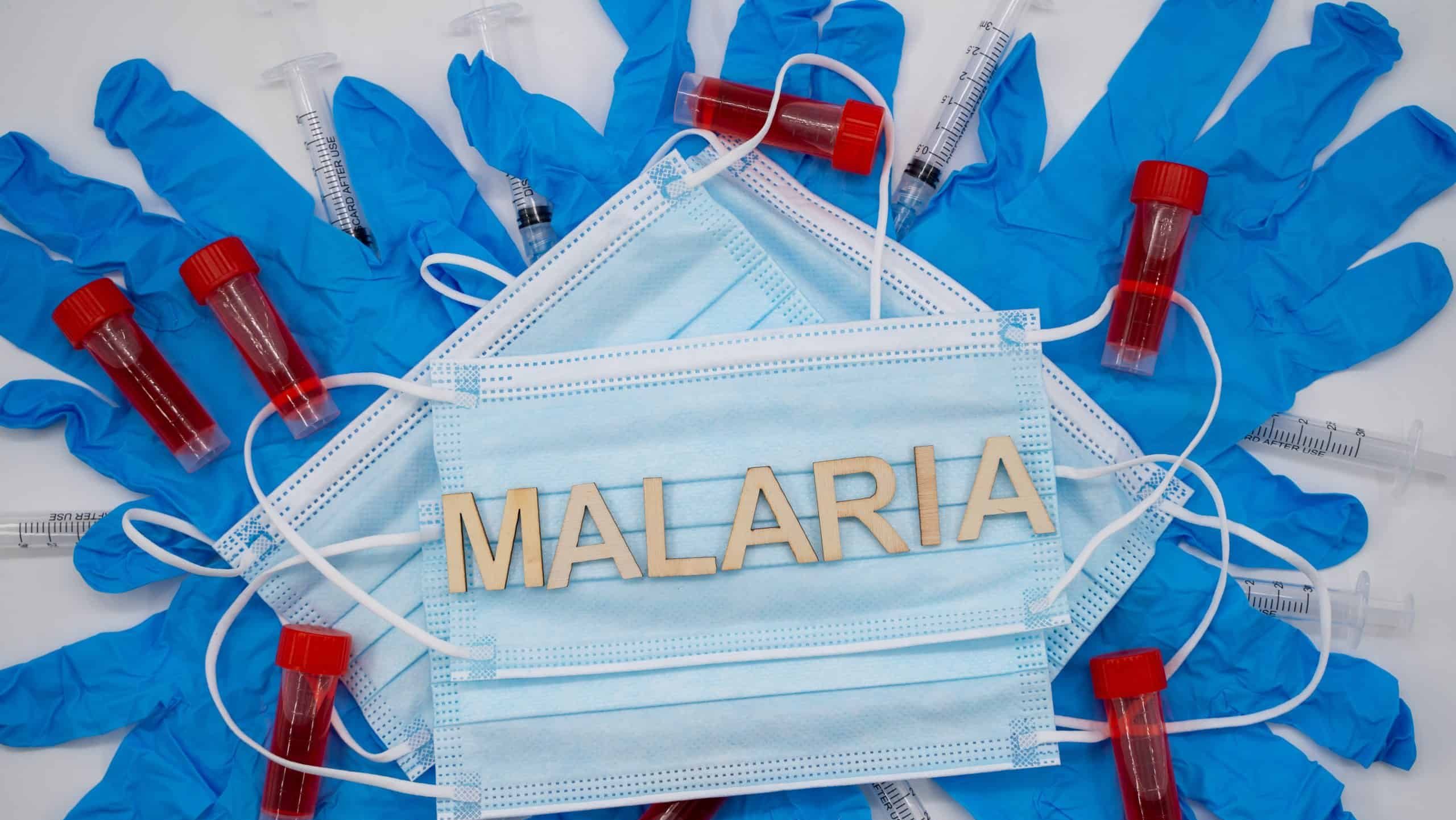 Malaria medical concept with masks gloves and laboratory samples.