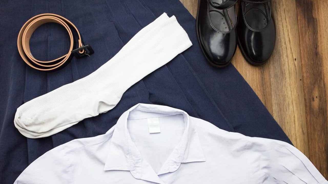 Still life : Thai Student girl uniform with wooden background on top view