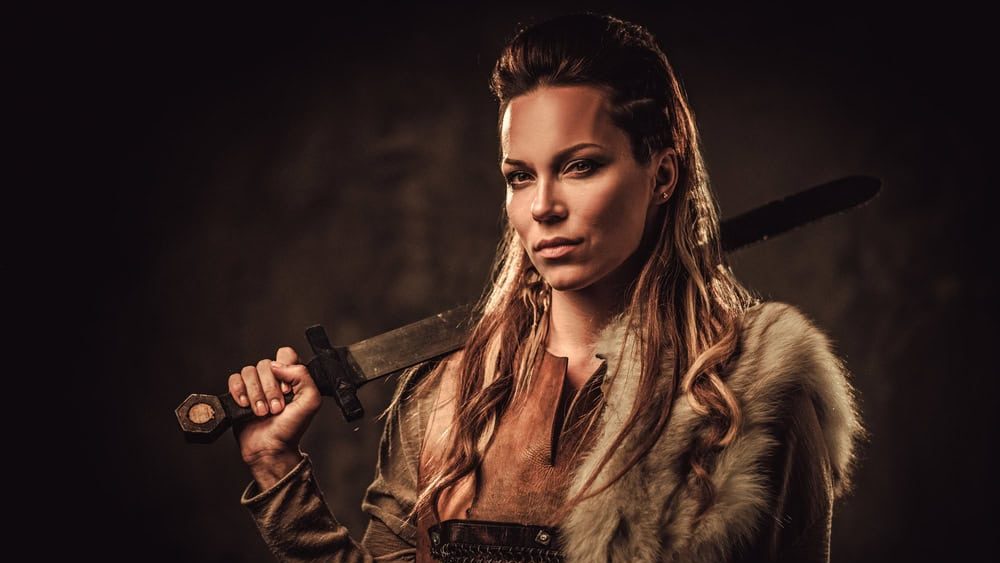 Viking,Woman,With,Sword,In,A,Traditional,Warrior,Clothes.