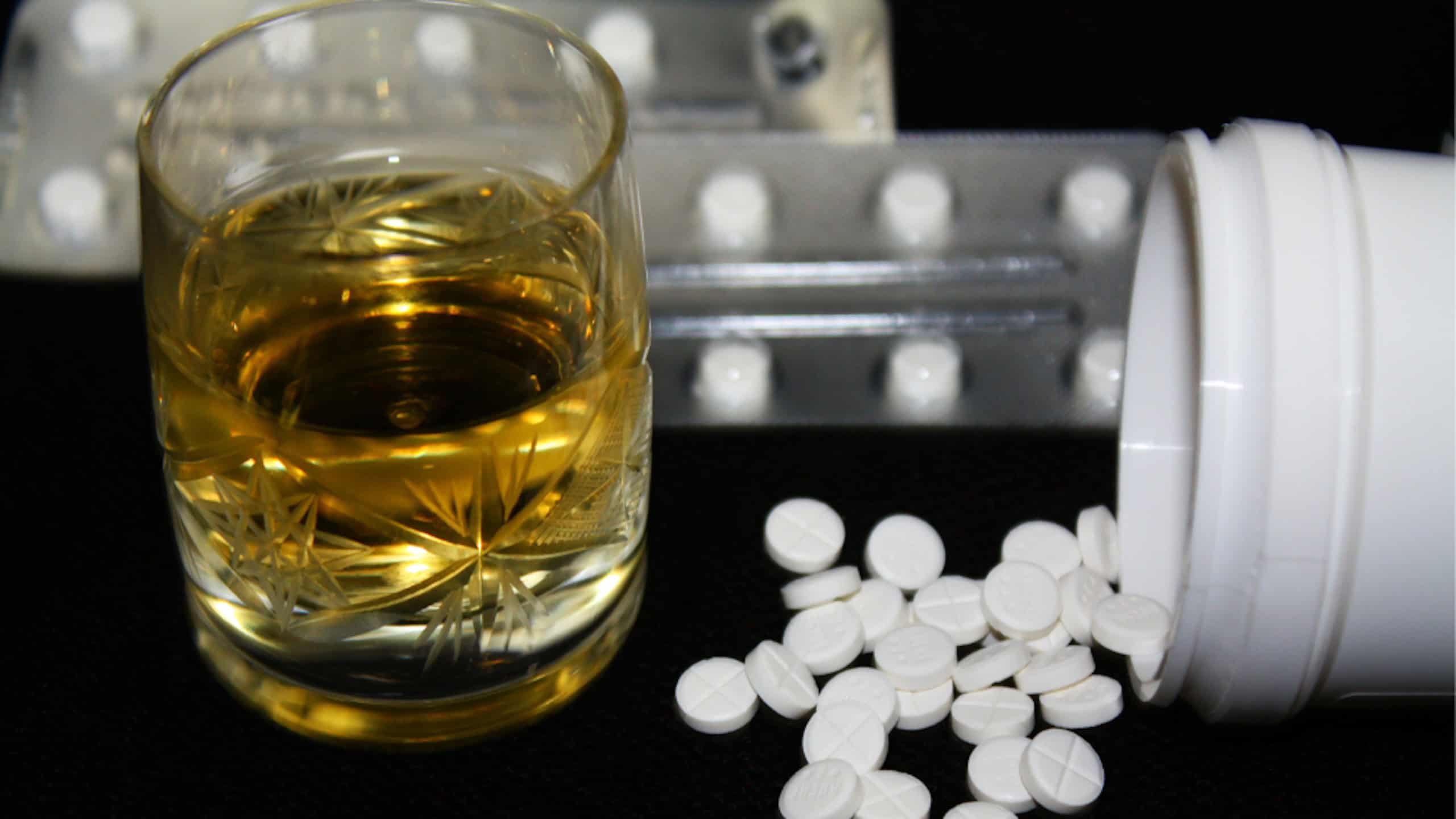 Benzodiazepines or other pills and glass of alcohol