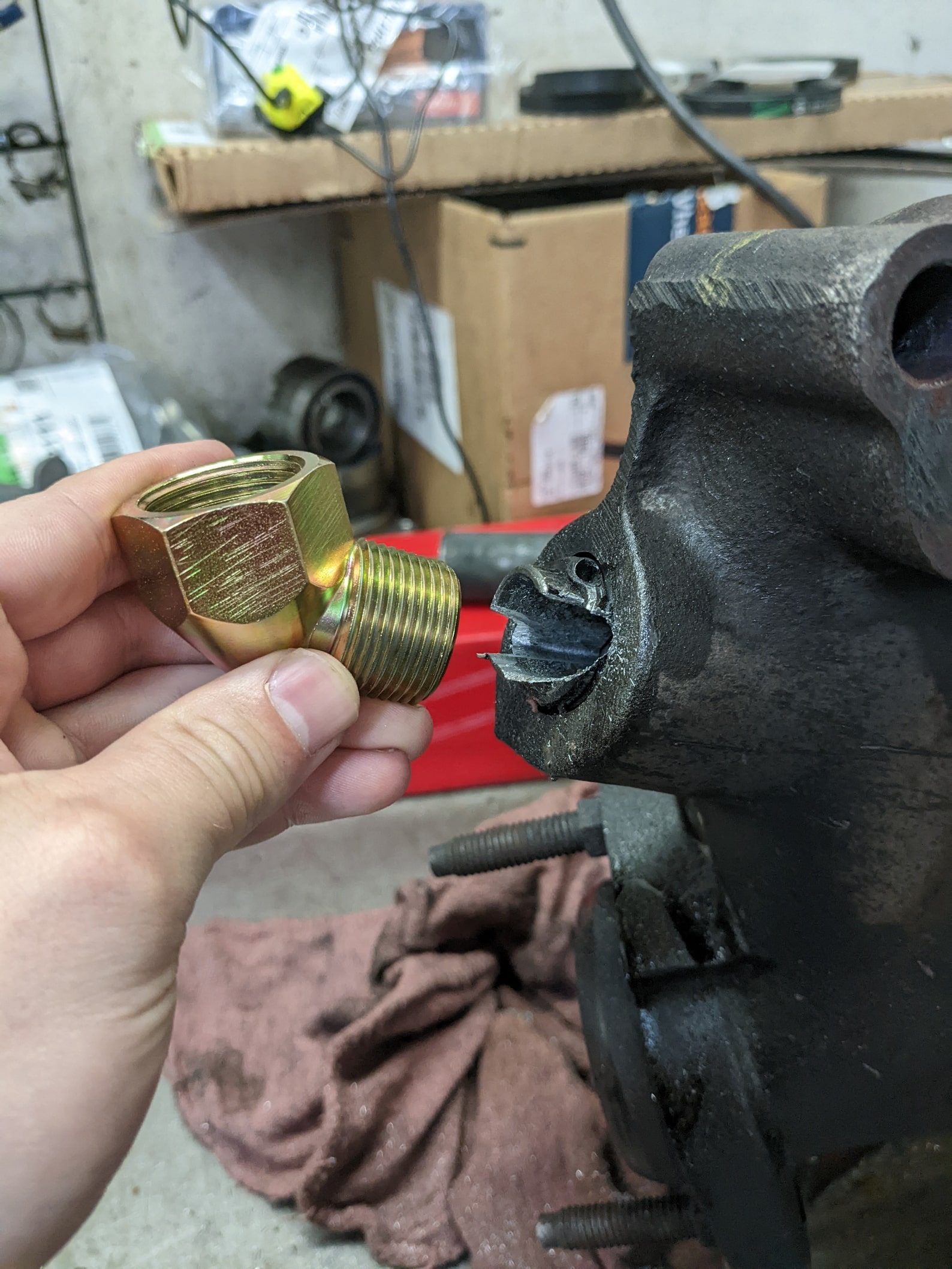 Engine component repair with new fitting for vehicle maintenance.