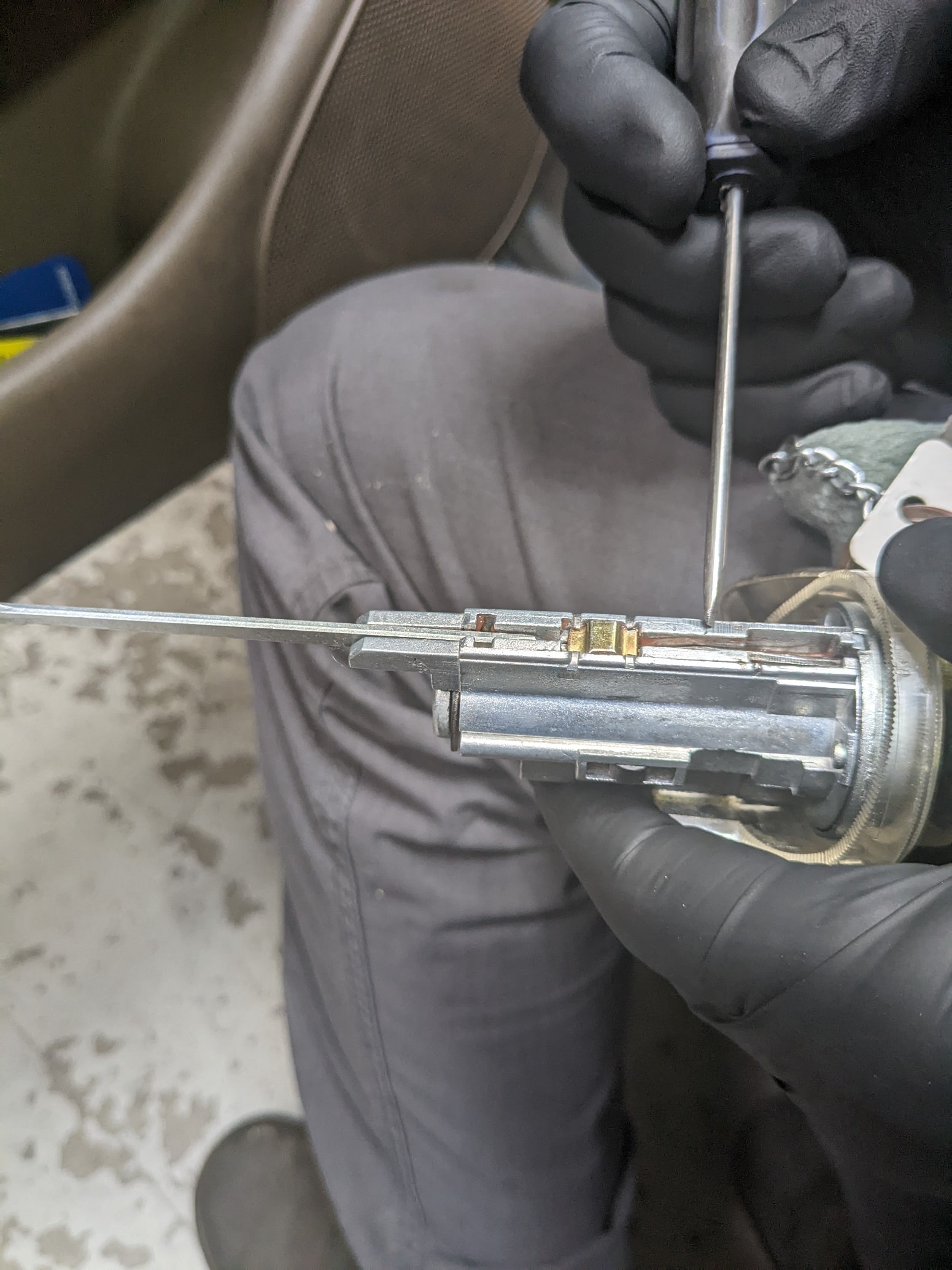 Engine repair technician working on a vehicle's fuel system at Auburn Service Center.