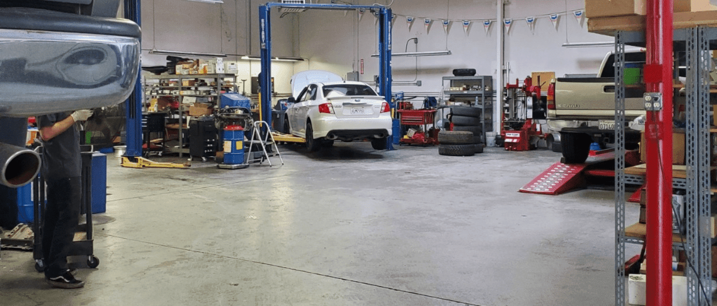 Auto repair shop with cars on lifts and tools in Auburn, Alabama.