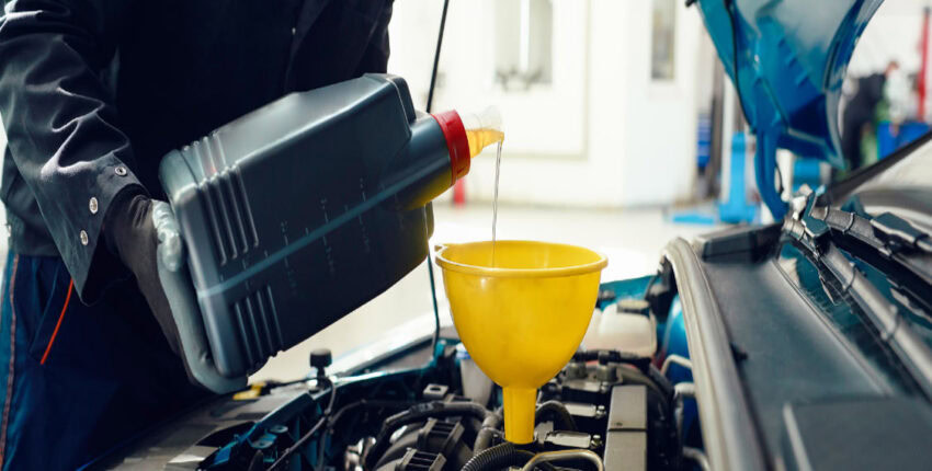 Engine oil being poured during a fluid exchange service.