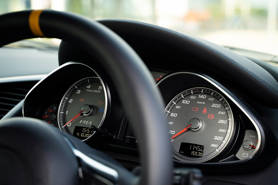 Car dashboard showing fluid levels and warning lights for maintenance.