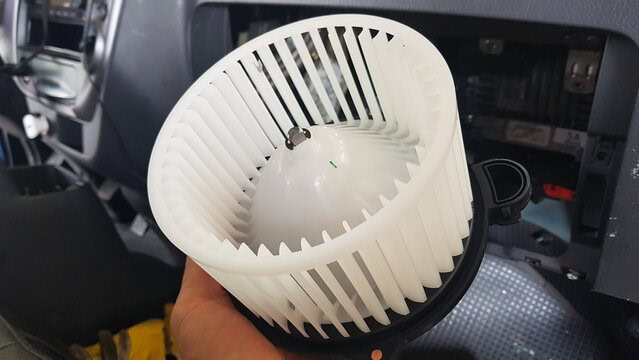 Vehicle A/C fan blower inside the dashboard for cooling comfort.