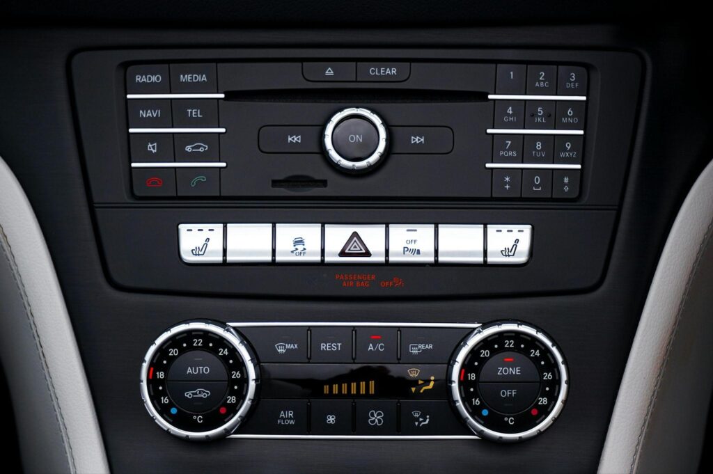 Car air conditioning control panel with temperature and fan settings.