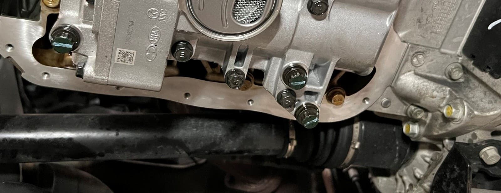 Engine oil pan and vehicle underside at Authentic Automotive Repair.
