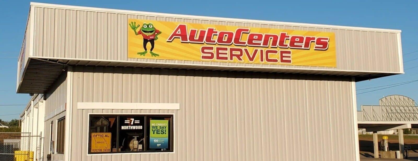 Auto Centers Service auto repair shop exterior with signage.