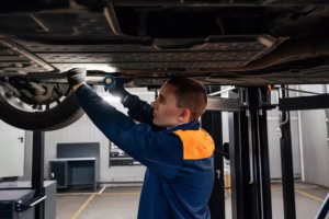 auto-mature-mechanic-repairman-uniform-using-wrench-working-with-auto-suspension-repair-garage-change-spare-part-check-mileage-car-checking-maintenance-service-concept