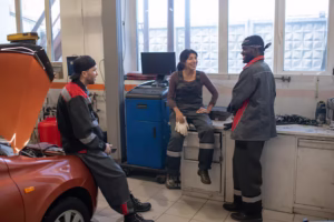 full-length-view-diverse-group-mechanics-chatting-break-car-repair-shop_