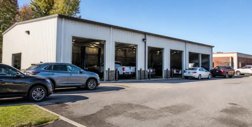 Auto repair shop with multiple service bays and parked vehicles.