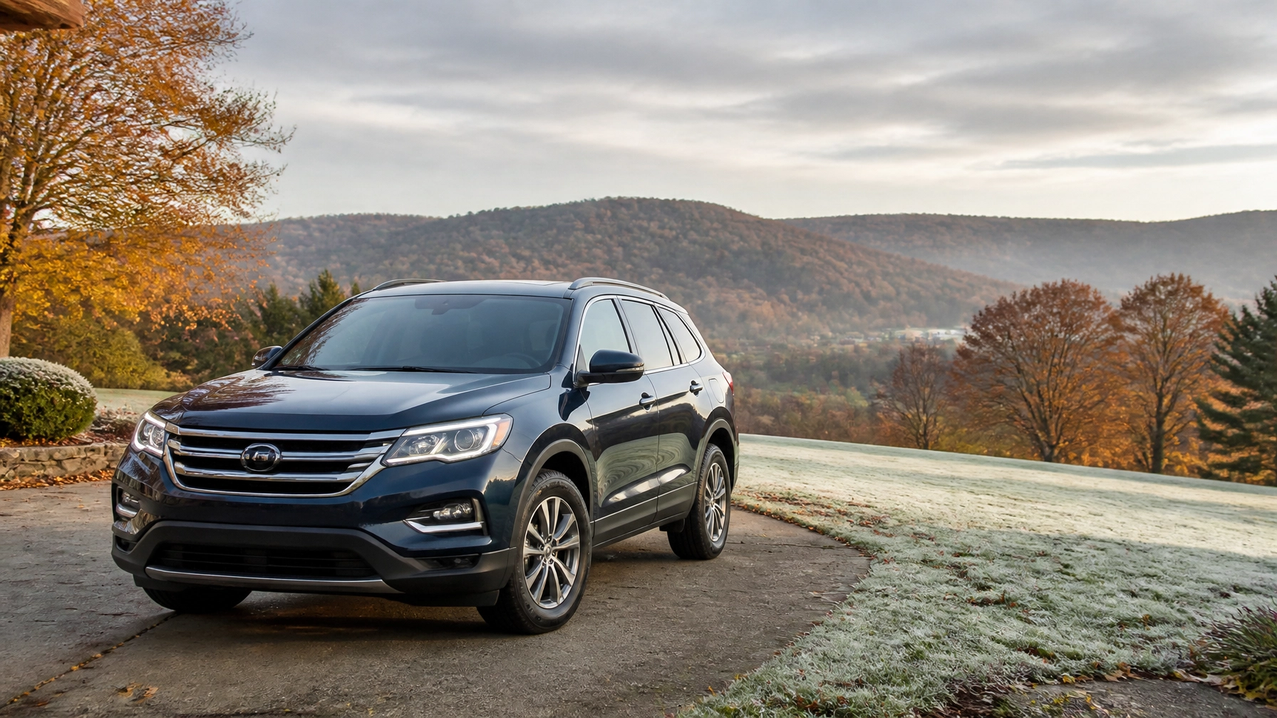 Black SUV parked on a scenic road with autumn trees and mountains in the background.