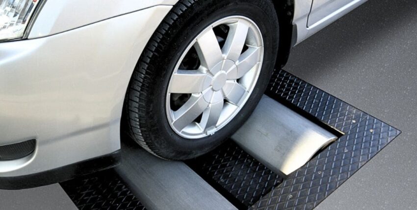 Car wheel on diagnostic lift for tune-up service.