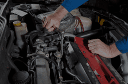 Mechanic inspecting car engine during general repair service.
