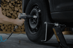 Technician changing a car tire during tire service at Autosauce Performance.