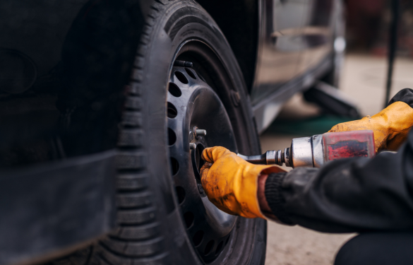 Re-torquing tire lug nuts during vehicle maintenance at Autosauce Performance.