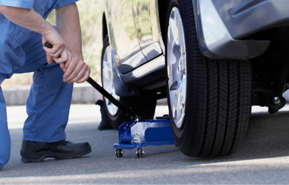 Wheel alignment being performed on a vehicle with a hydraulic lift.