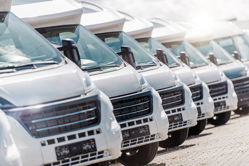 Fleet of service vans at Auto Tech Solutions for vehicle maintenance and repairs.