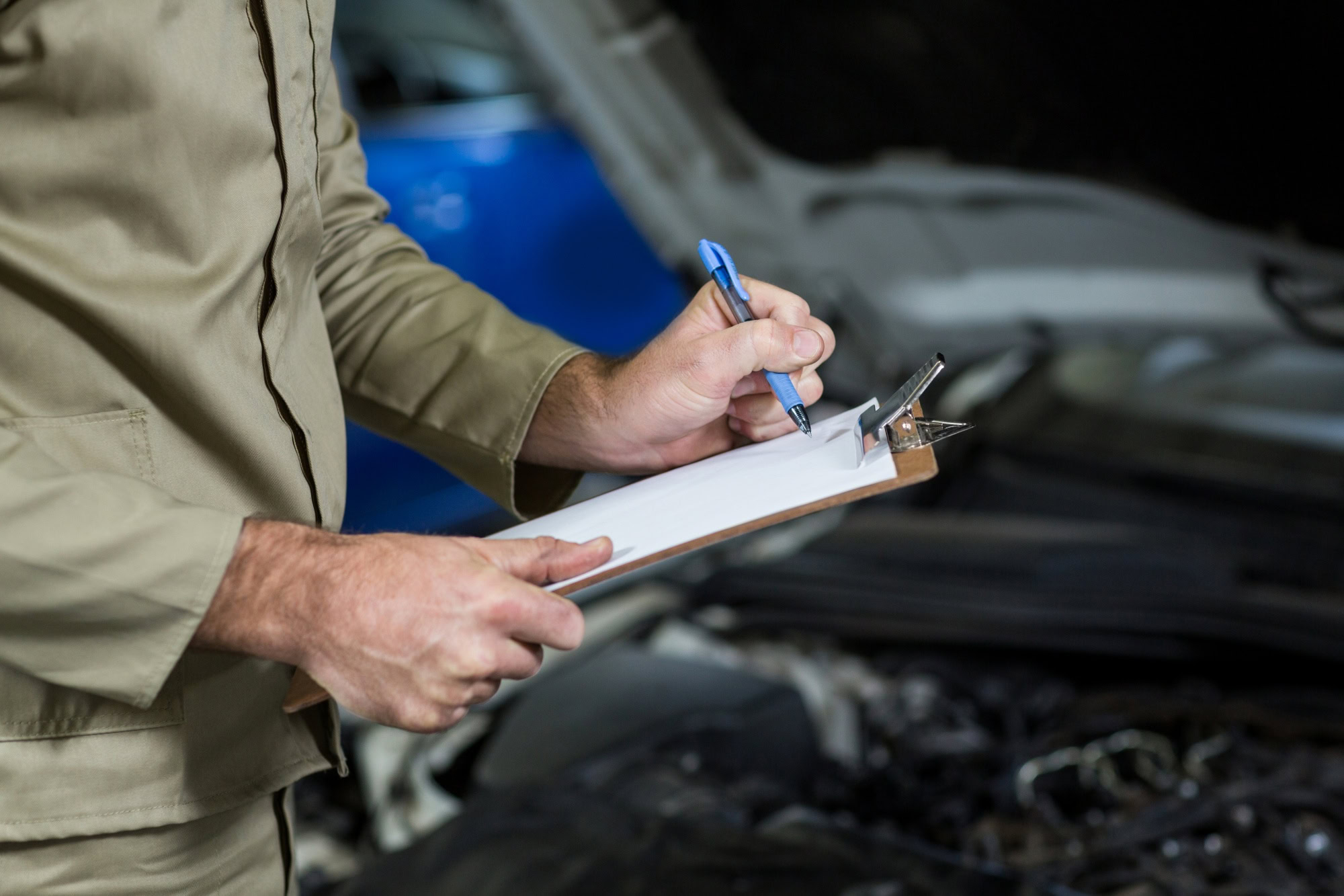 Mechanic conducting inspection of car's emissions