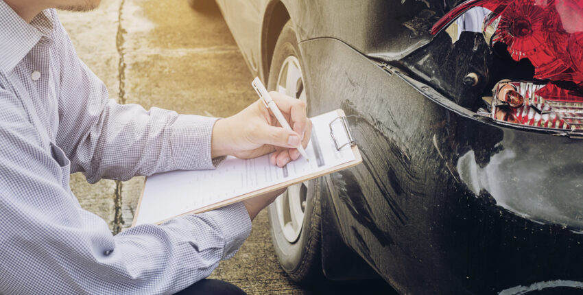 Technician inspecting vehicle for emissions testing in Ontario.