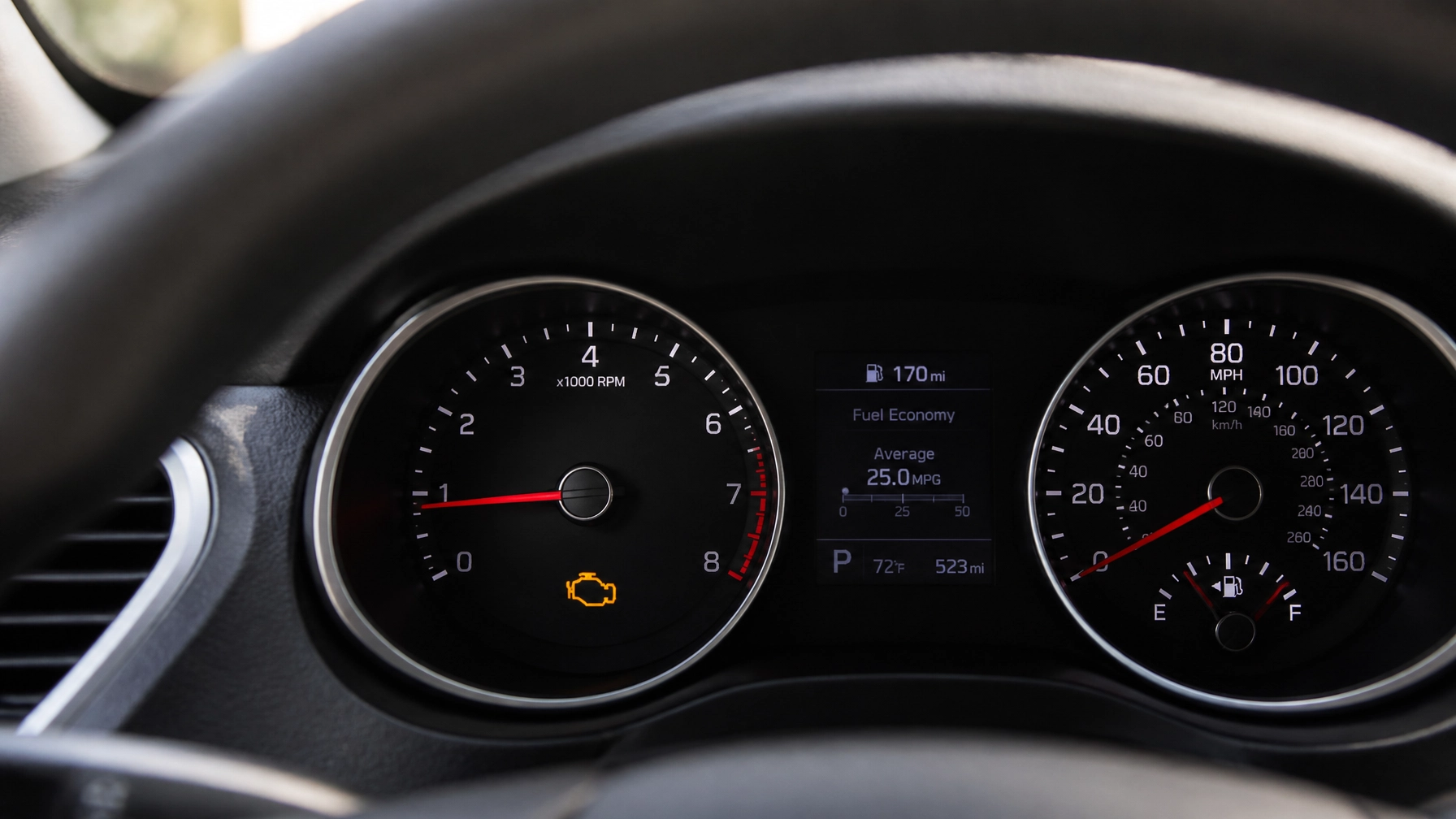 Car dashboard showing speed, fuel, and check engine light at Best Buy Auto Service.