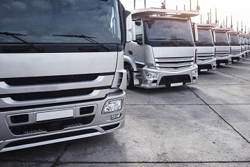 Truck fleet parked at Big Sky Tire and Repair for automotive services.
