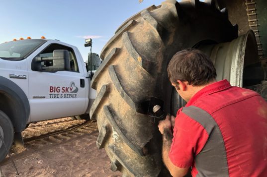 Agricultural tires being serviced on a large tractor at Big Sky Tire and Repair.