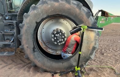 Tire inspection and repair being performed on a large tractor tire at Big Sky Tire and Repair.