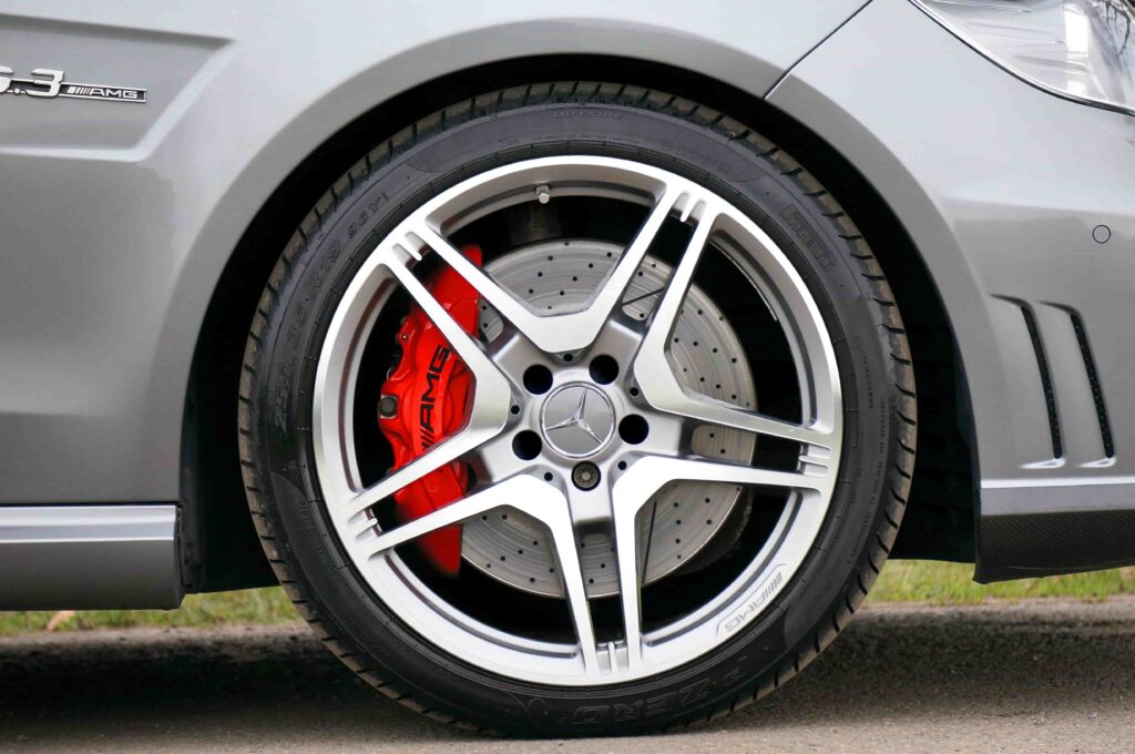 Close-up of a high-performance car tire and brake system at Big Sky Tire and Repair.