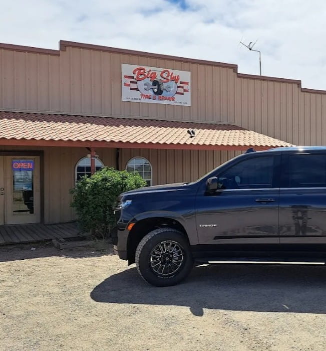 Big Sky Tire and Repair shop with a parked truck in front.