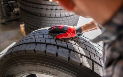 Technician inspecting tire for damage at Big Sky Tire and Repair.