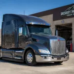 Large black semi-truck parked outside Desert Mountain Truck Service.