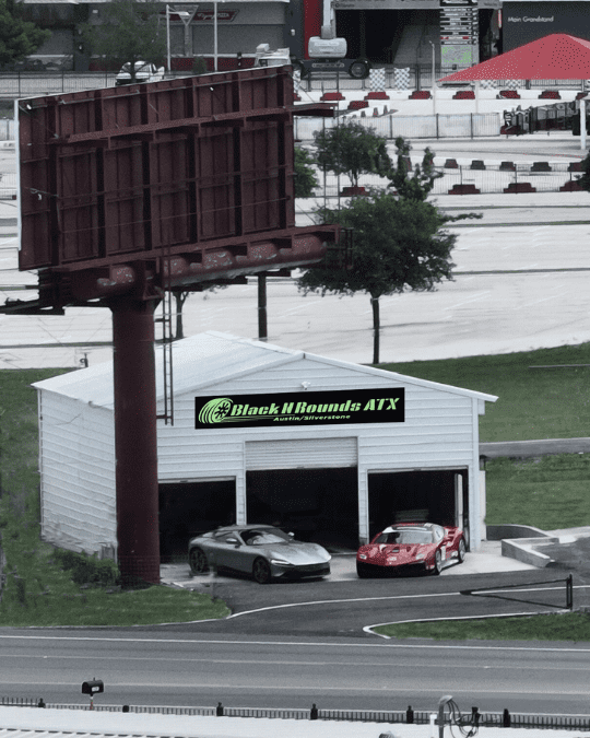 Black n Rounds ATX contact sign with cars in front of the building.