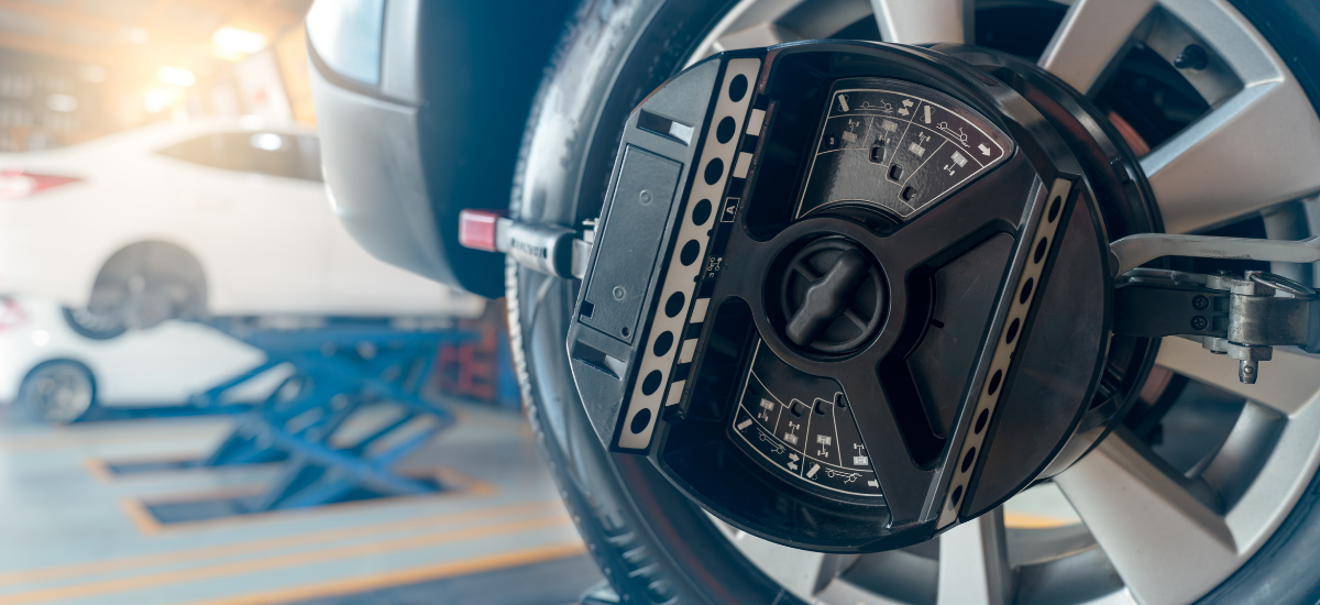 Professional wheel alignment being performed on a car at Black n Rounds ATX.