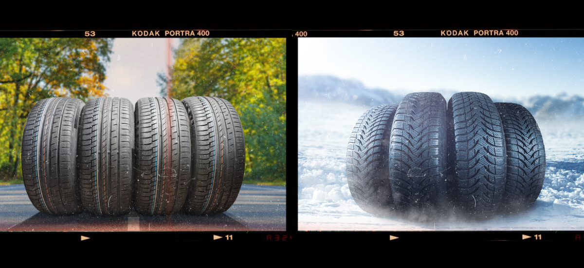 Set of four tires on a road with autumn trees and snow, showing weather impact on tire performance.