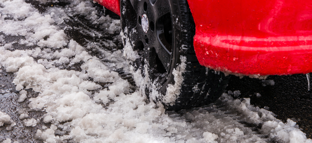 Winter tire on snow-covered road in Austin, TX.