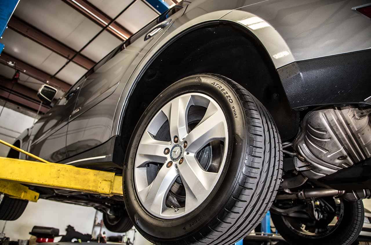 BMW tire and wheel maintenance in a professional auto repair shop.