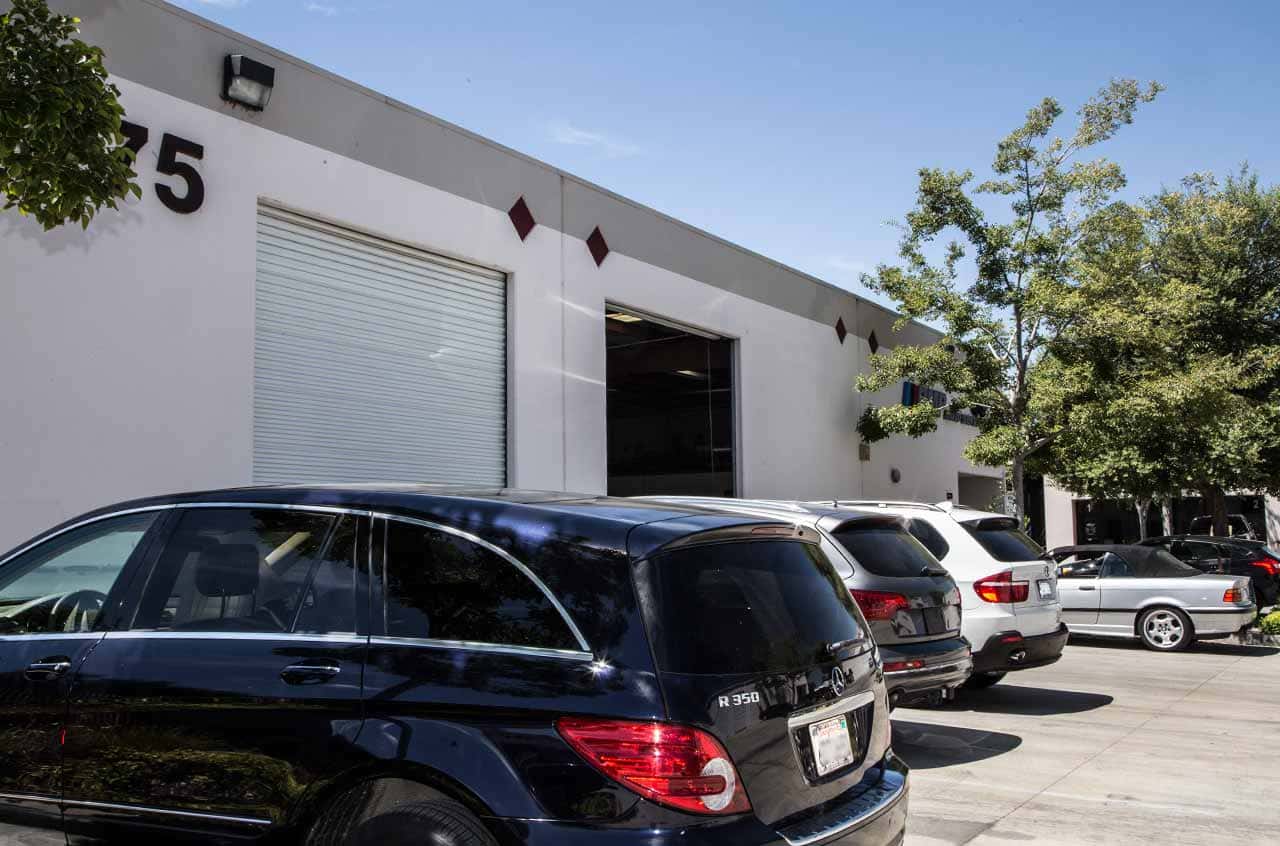 Auto repair shop with parked cars outside BMP Auto Service facility.