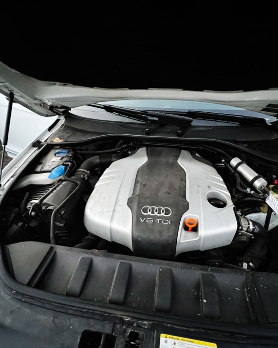 Audi V6 TDI engine under hood during repair at BMP Auto Service.