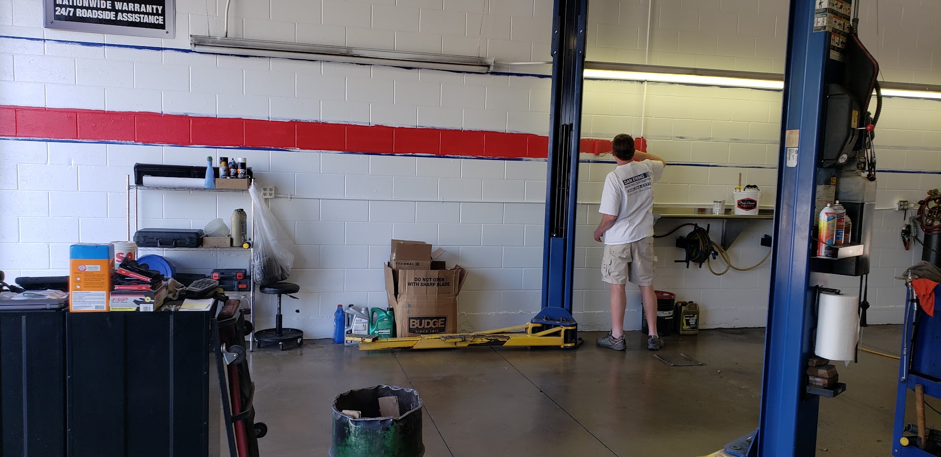 Auto repair technician working on vehicle exhaust system.