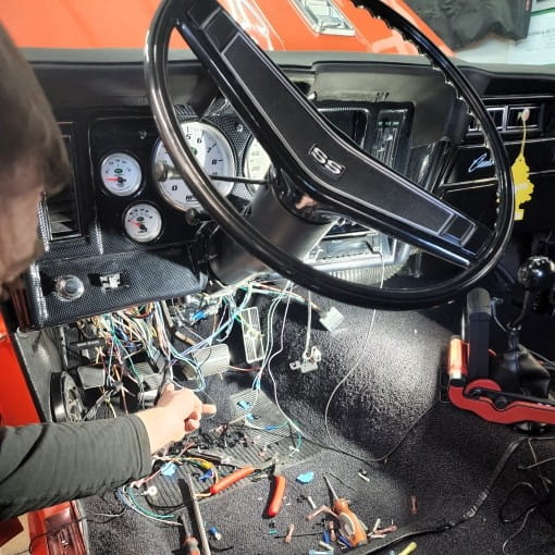Engine wiring repair in a vehicle dashboard at Boise Muffler Auto Repair.