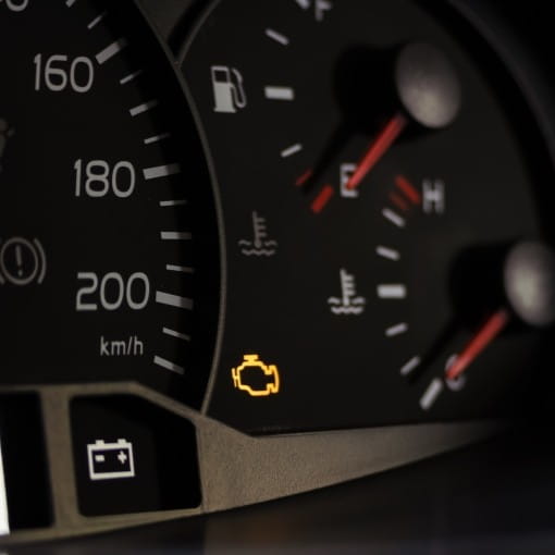 Engine warning light illuminated on vehicle dashboard, indicating potential engine issues.