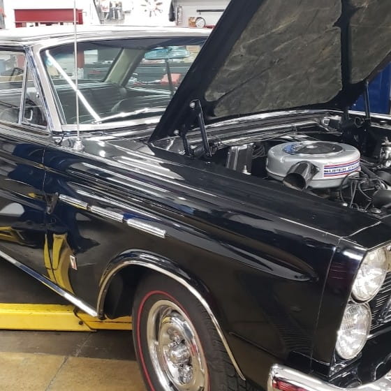 Vintage black classic car with open hood at Boise Muffler Auto Repair.