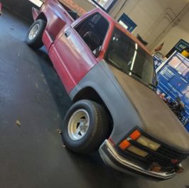 Custom offroad truck with lifted suspension and rugged tires.